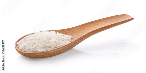 Dry white jasmine rice in wood spoon on a white background