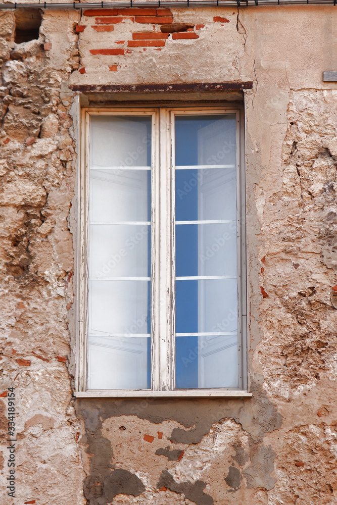 Old windows on the facade of a house