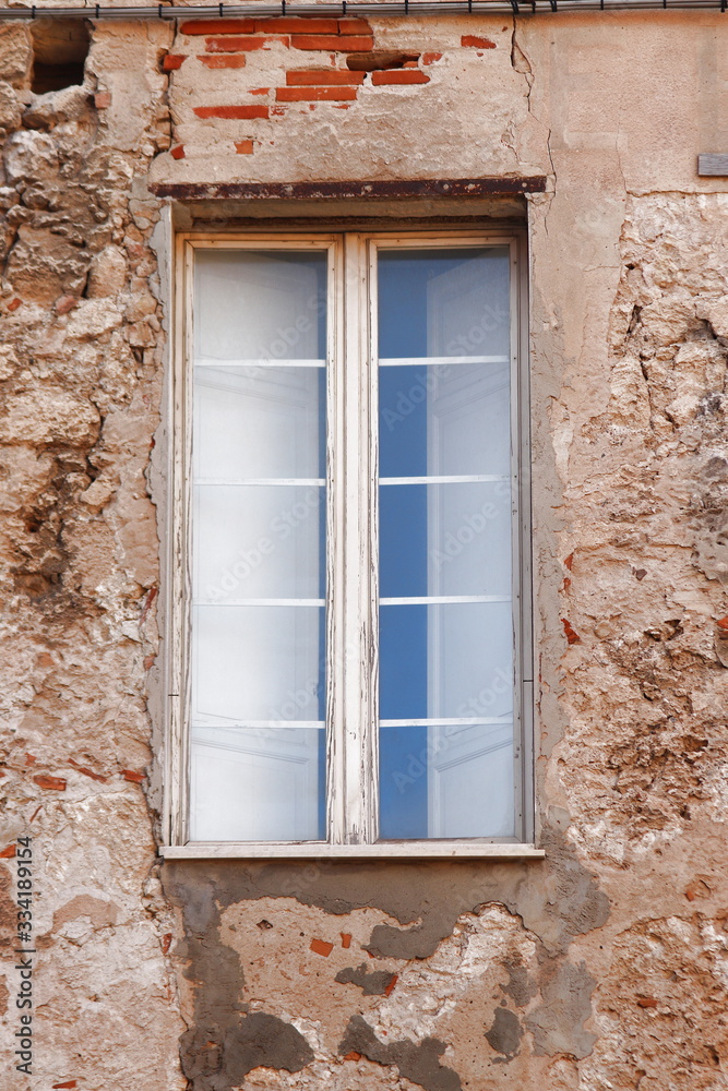 Fototapeta premium Old windows on the facade of a house