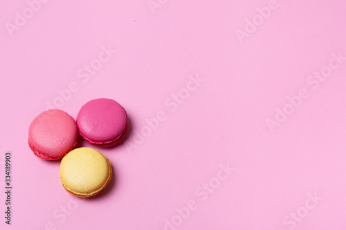Fresh tasty macaron cake or macaroon on pink pastel background top view. 
