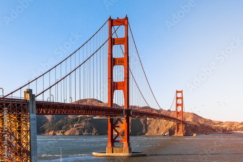 Beautiful view of famous Golden Gate Bridge in San Francisco in the rays of the setting sun