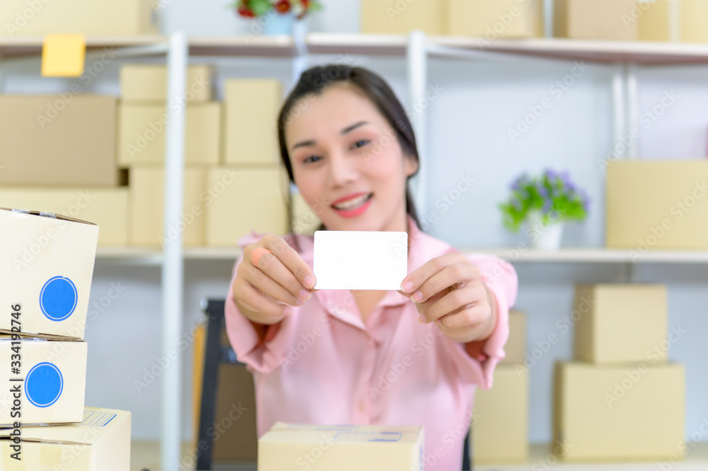 Young woman holding credit card and using laptop computer, Happy woman doing online shopping at home, Online shopping concept.. Young woman holding credit card and using laptop computer, Happy woman doing online shopping at home, Online shopping concept..
