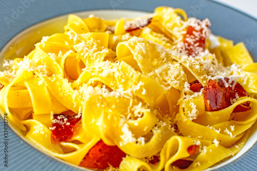 Tagliatelle egg pasta with speck, Italian cuisine dish from Trentino photo