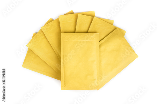 A pile of yellow shipping envelopes isolated on white