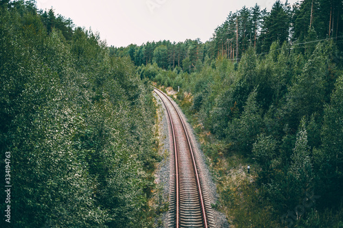 railway for trains in a green forest in summer