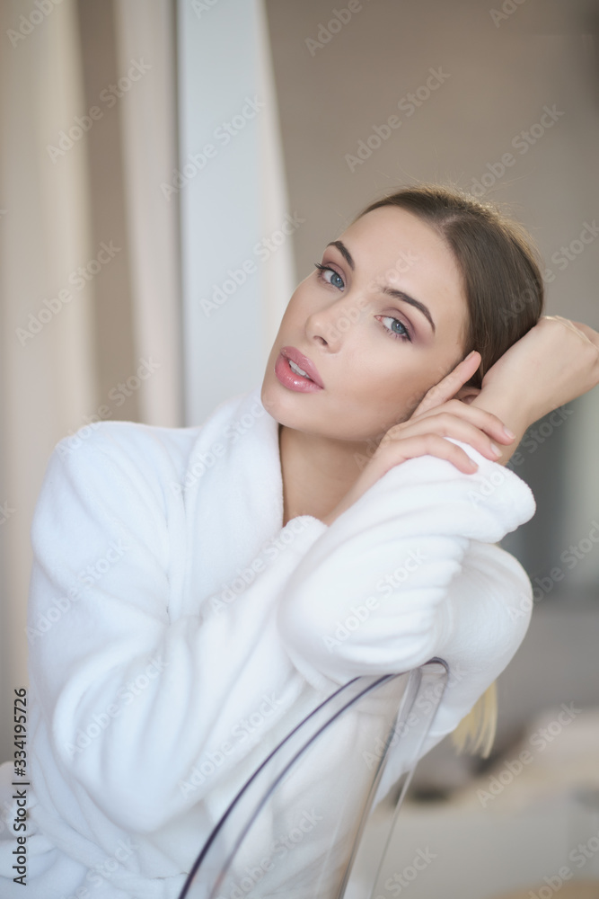 woman resting in a bathrobe at home