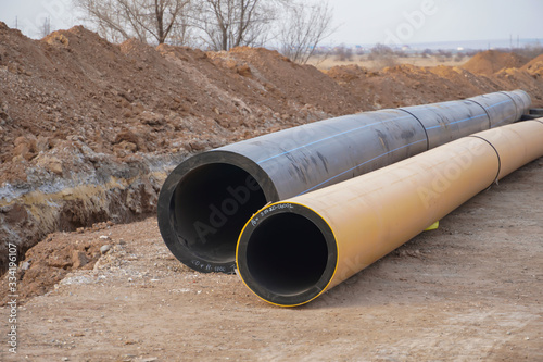 Wallpaper Mural The new propylene pipeline DN 350 and DN 500 prepared for laying in a trench and for pumping oil and gas for an oil refinery Torontodigital.ca