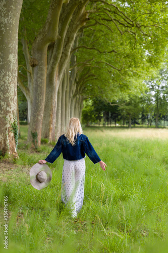 Blonde woman walking in woods