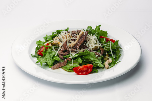 salad with egg on a plate on a white background