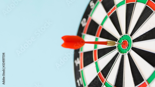 Defocused board with arrow in bull's-eye