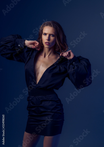 Portrait of beautiful brunette woman in black dress. Fashion photo,.