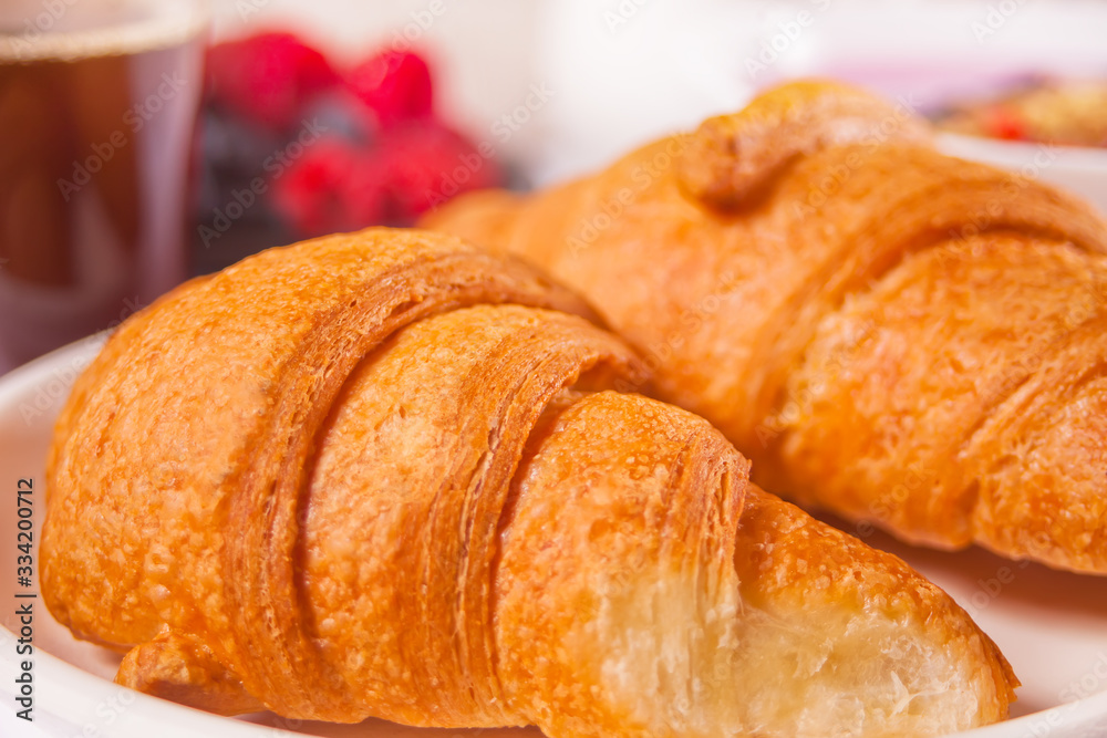 Fresh croissants buns with berries. Breakfast concept.