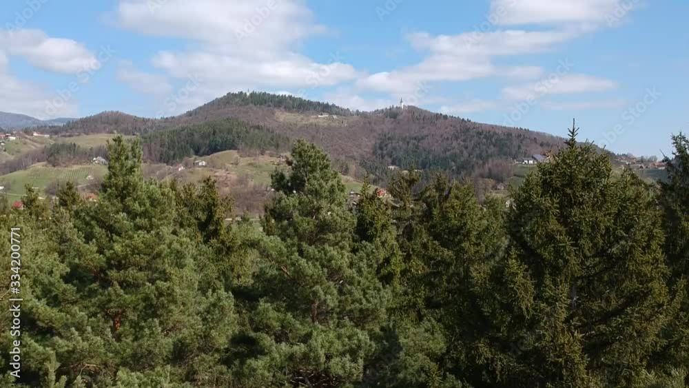 Drone video lifting up through the trees and capturing nice landscape