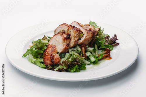 slices of sliced Turkey with salad on a white background