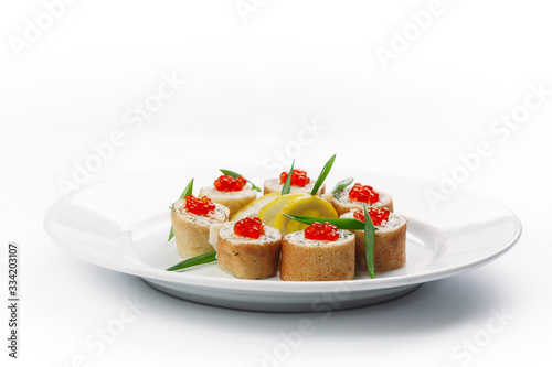 stuffed pancakes with caviar and lemon slices on a white background