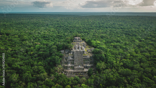 Aerial view of the pyramid, Calakmul, Campeche, Mexico. Ruins of the ancient Mayan city of Calakmul surrounded by the jungle