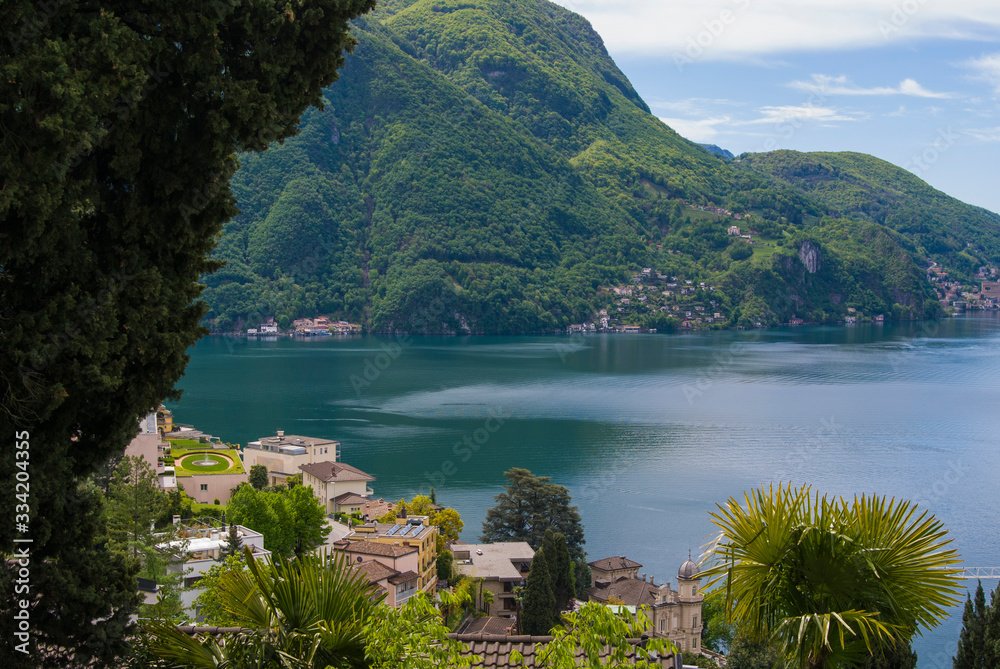 View of Lake Lugano and Mount San Salvatore on a sunny summer day. Alpine mountain scenery in the city of Lugano, Switzerland. 