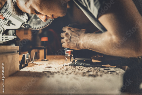 carpenter working with plane on wooden background photo