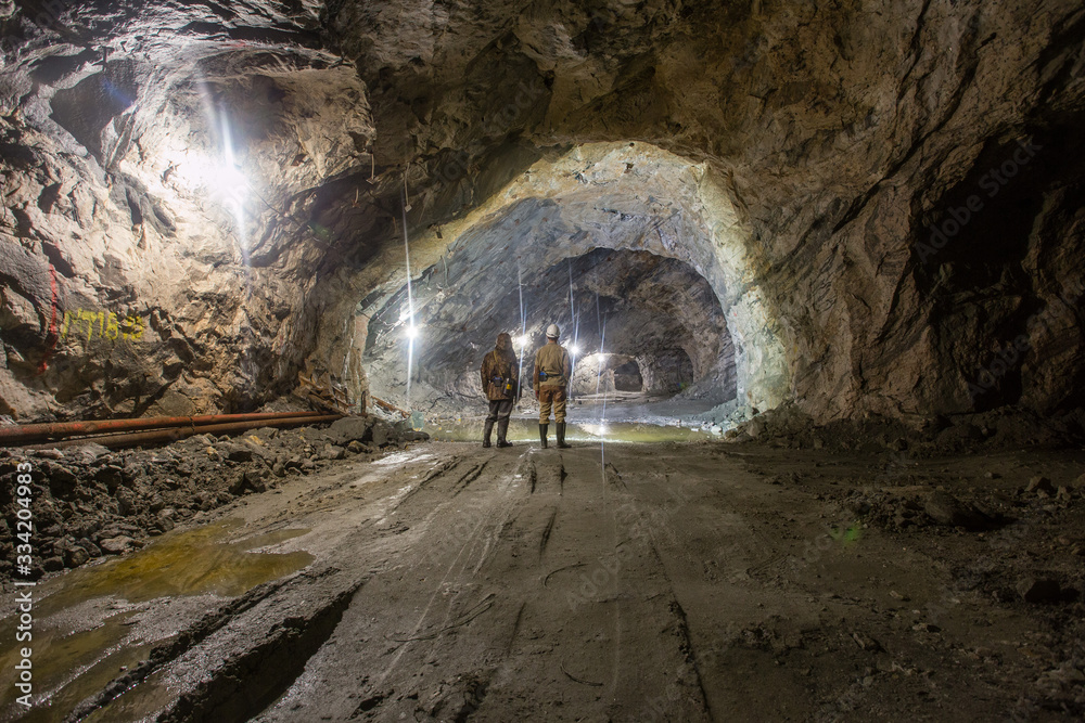 Miners in underground gold quartz mine tunnel