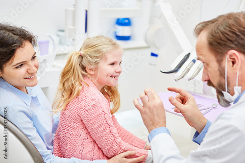 Pediatric dentist explains mother and child treatment