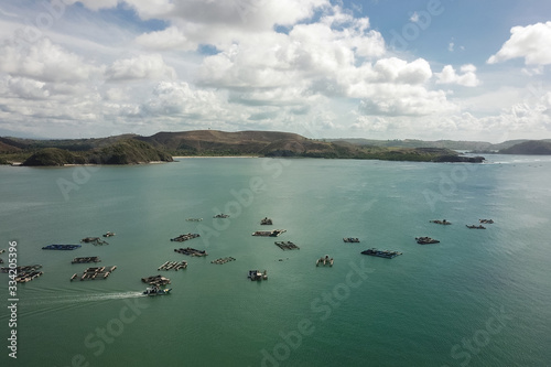 Aerial view of traditional floating fishing cages, Gerupuk Bay, Lombok, Indonesia photo