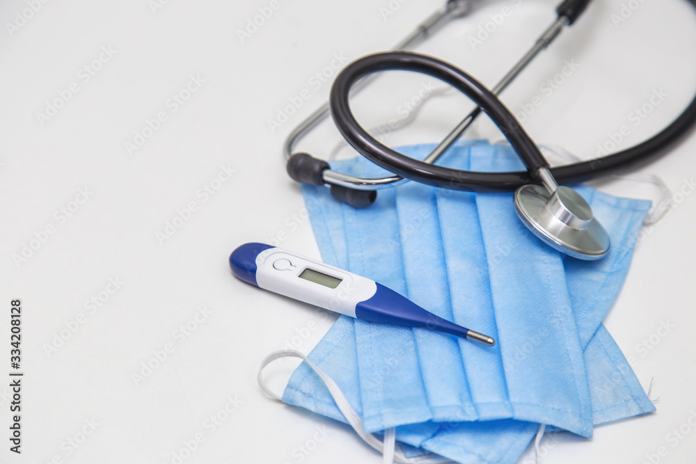 Protection Mask, Thermometer And Stethoscope for protection against viruses on a white background Protection Mask, Thermometer And Stethoscope for protection against viruses on a white background