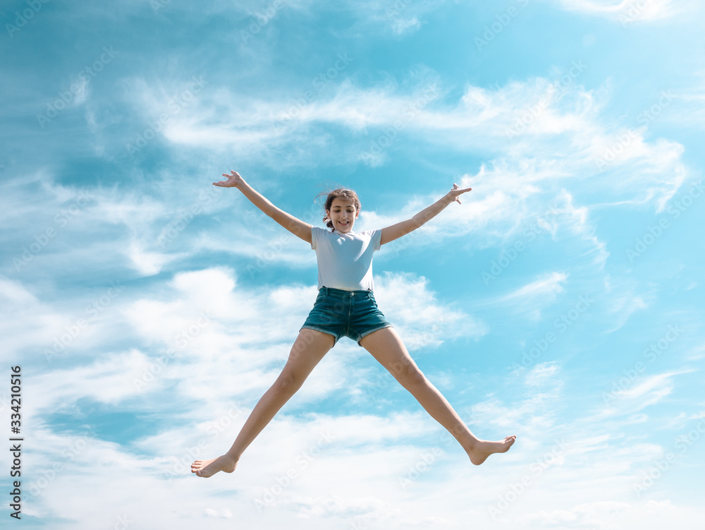 teenage girl jumping high, sky as background teenage girl jumping high, sky as background