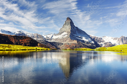 Fototapeta Naklejka Na Ścianę i Meble -  Picturesque view of Matterhorn Cervino peak and Stellisee lake in Swiss Alps. Day photo with blue sky. Zermatt resort location, Switzerland. Landscape photography