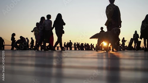 people walking along the promenade and enjoying gold sundown. photo