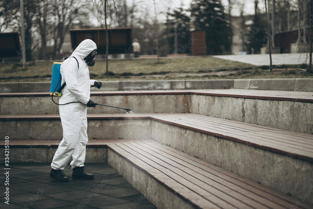 Cleaning and Disinfection at town complex amid the coronavirus epidemic Professional teams for disinfection efforts Infection prevention and control of epidemic Protective suit and mask