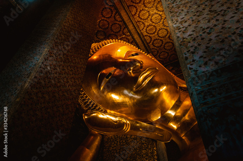 Photography Statue of lying gold Buddha in Wat pho (Pho Temple) in Bangkok, Thailand