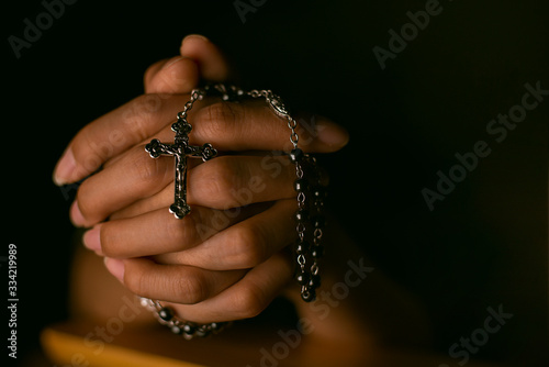 Christian women pray for blessings with faith on a black background.