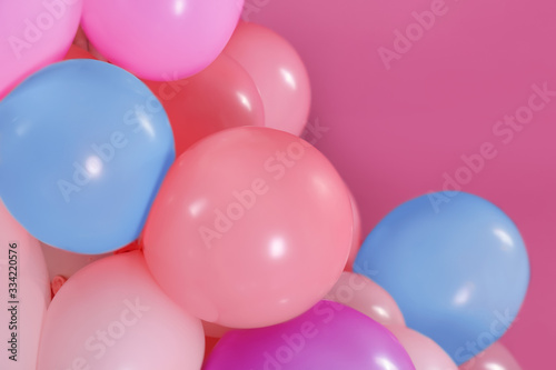 Beautiful colorful balloons on pink background, closeup. Party decor