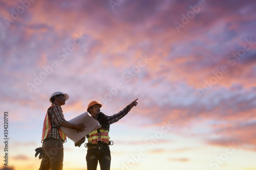 Two Construction workers on a construction site looking at plans, Thailand