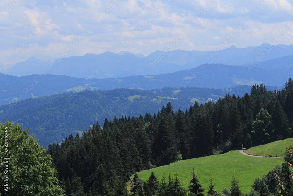 Fototapeta premium Beautiful green Alp mountains and hills from Pfaender Mountain in Bregenz, Vorarlberg, Austria.