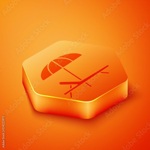 Isometric Sunbed icon isolated on orange background. Beach umbrella and Sun lounger. Orange hexagon button. Vector Illustration