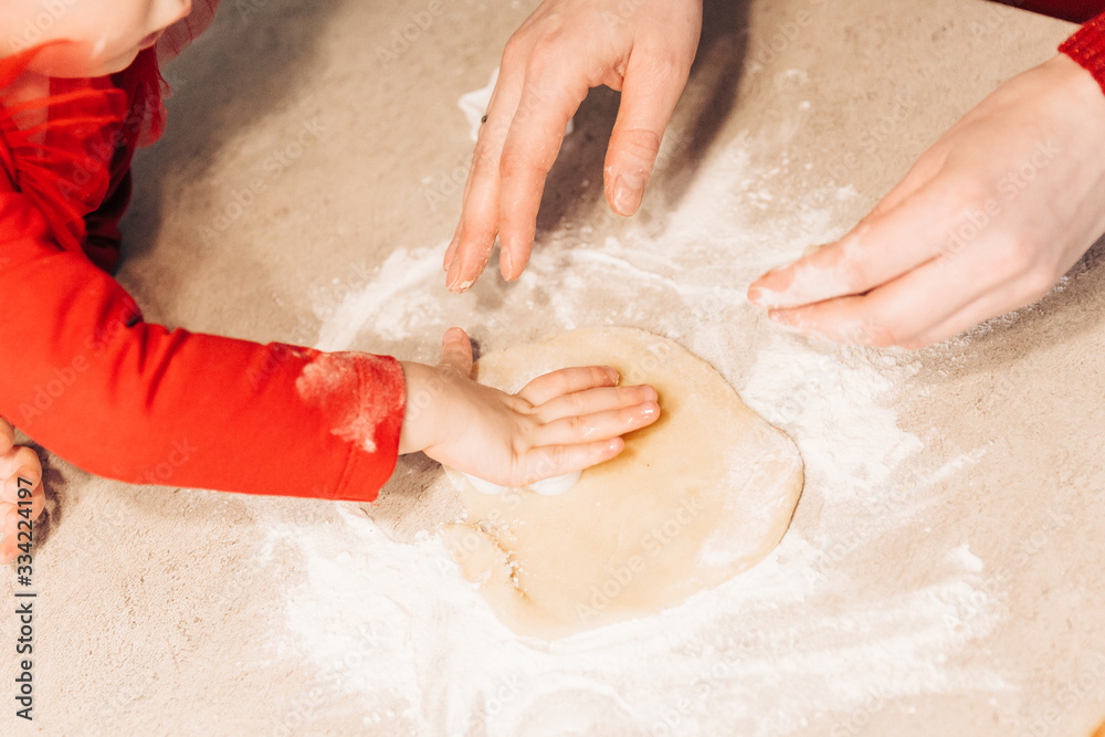 Child cuts out cookies from dough Child cuts out cookies from dough