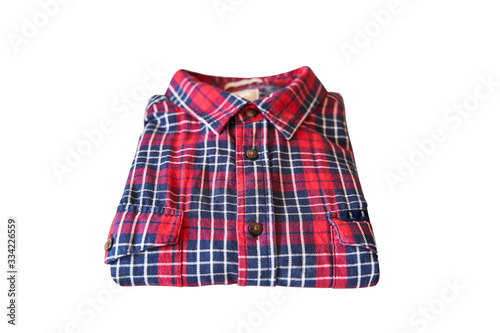 Red checkered flannel shirt folded on a white isolated background. Top view.