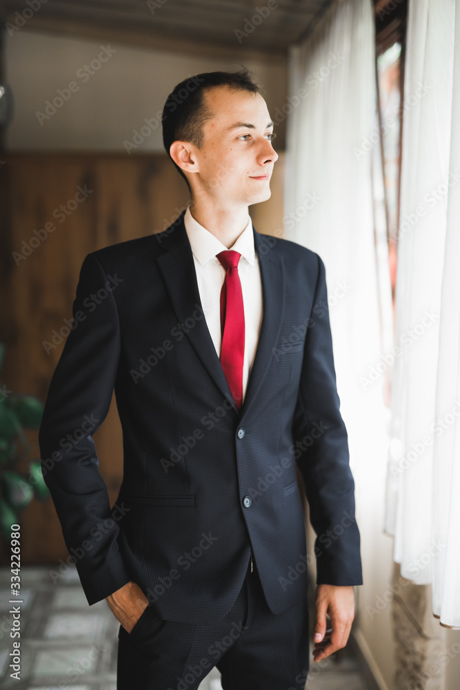 Young handsome man relaxing at his apartment in a hotel after business meeting Young handsome man relaxing at his apartment in a hotel after business meeting