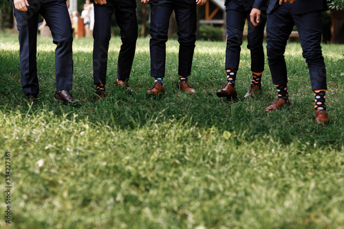 stylish men's socks. Stylish suit, men's legs, multicolored socks and new shoes. Concept of style, fashion, beauty and vacation. selective focus. copy space