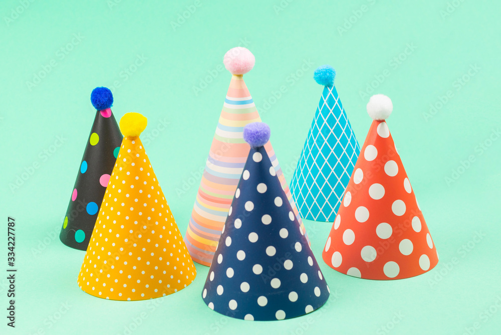 Colorful birthday caps on mint background. Colorful birthday caps on mint background.