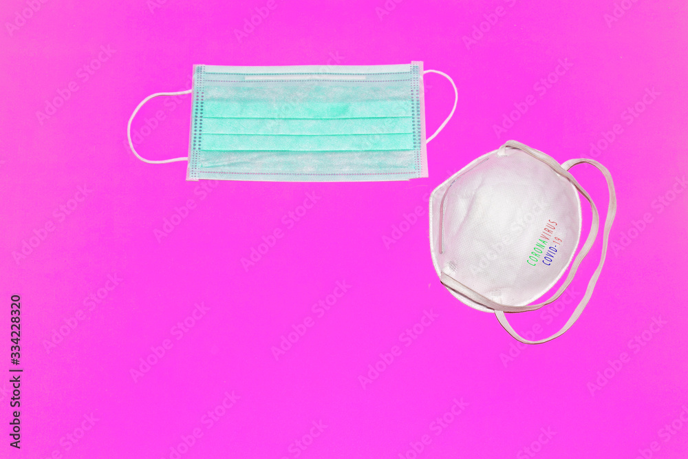 Obraz premium Protective mask and virus spread on pink background with inscription CORONAVIRUS COVID-19.