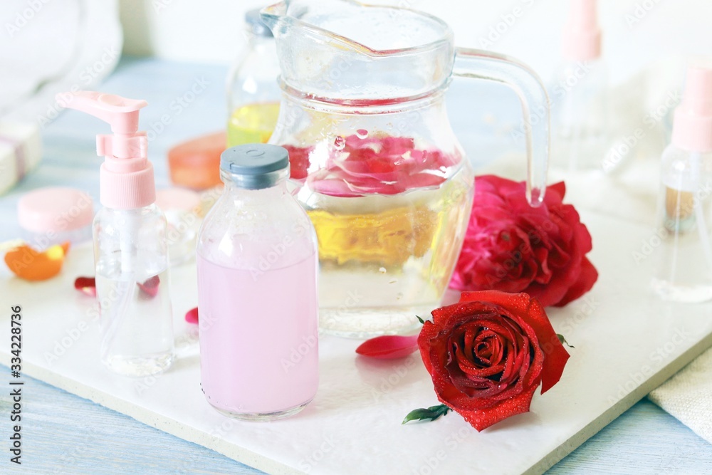 Fresh roses, soap, petals, water and oil on the table for the preparation of natural cosmetics, spa, hygiene procedures, healthy lifestyle