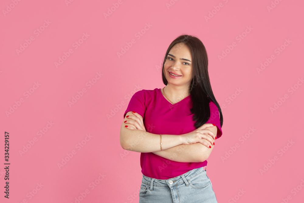 Hands crossed.Monochrome portrait of young caucasian brunette woman isolated on pink studio background. Beautiful female model. Human emotions, facial expression, sales, ad concept. Youth culture. Hands crossed.Monochrome portrait of young caucasian brunette woman isolated on pink studio background. Beautiful female model. Human emotions, facial expression, sales, ad concept. Youth culture.