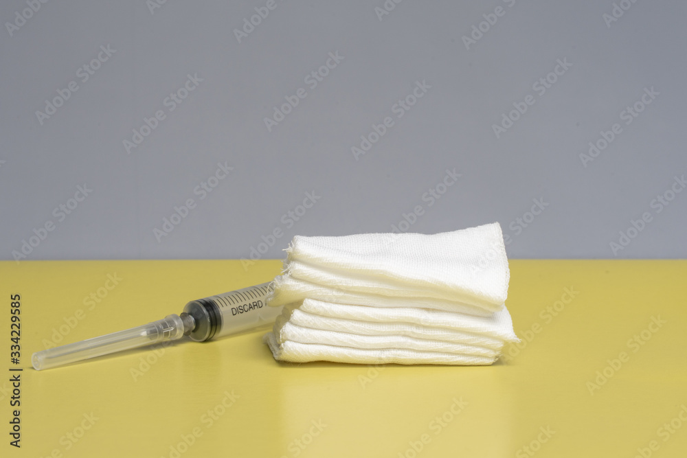 injection kit, syringe and sterile wipes on a yellow background. antiviral treatment injection kit, syringe and sterile wipes on a yellow background. antiviral treatment