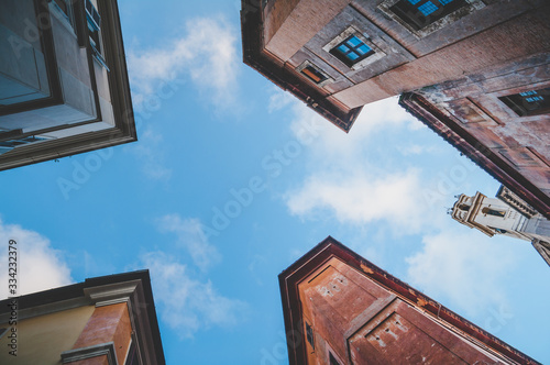 Sky between old buildings walls from below in Rome, Italy