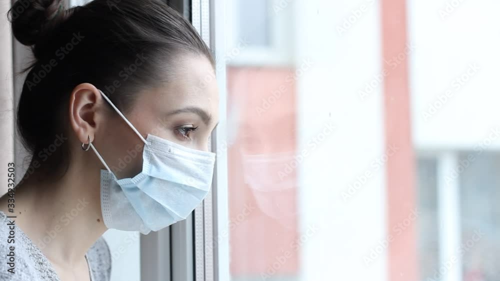 Young woman in medical mask stay isolation at home for self quarantine.  Home quarantine, prevention COVID-19, Coronavirus outbreak situation