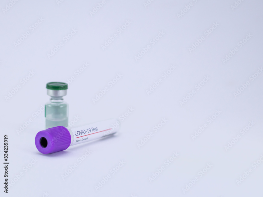 One Vaccine vial and an empty blood sample tube on white background for Corona virus test and cure. One Vaccine vial and an empty blood sample tube on white background for Corona virus test and cure.