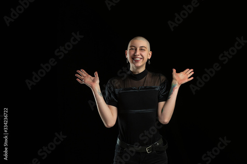 Laughting, cute. Monochrome portrait of young caucasian bald woman isolated on black studio background. Beautiful female model. Human emotions, facial expression, sales, ad concept. Youth culture.