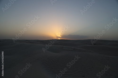 The sunset on the white dunes of the Al Khaluf Bay, Oman